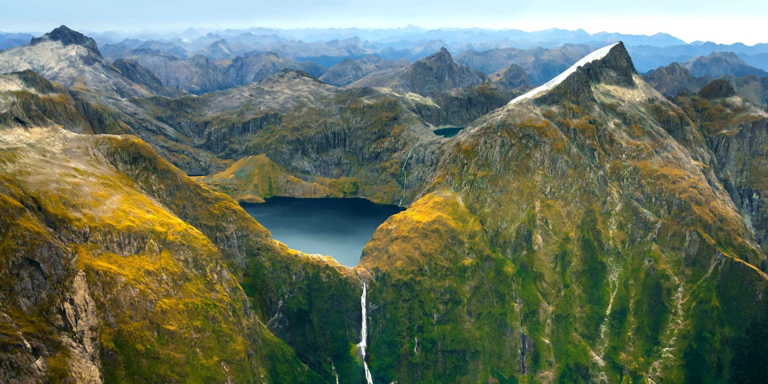 Amazing aerial view of mountain Lake Quill and Sutherland Falls on the scenic flight from Milford Sound to Queenstown, Fiordland, New Zealand