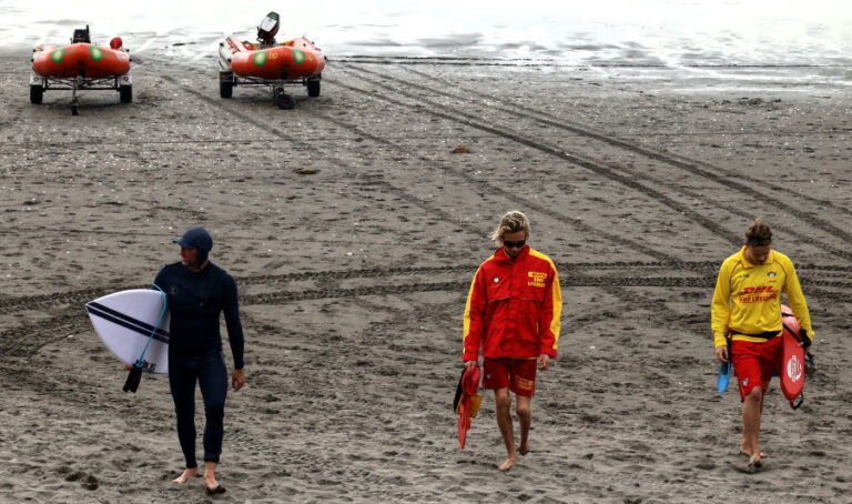 Beach culture lifeguards and surfer Ngarunui Beach, New Zealand