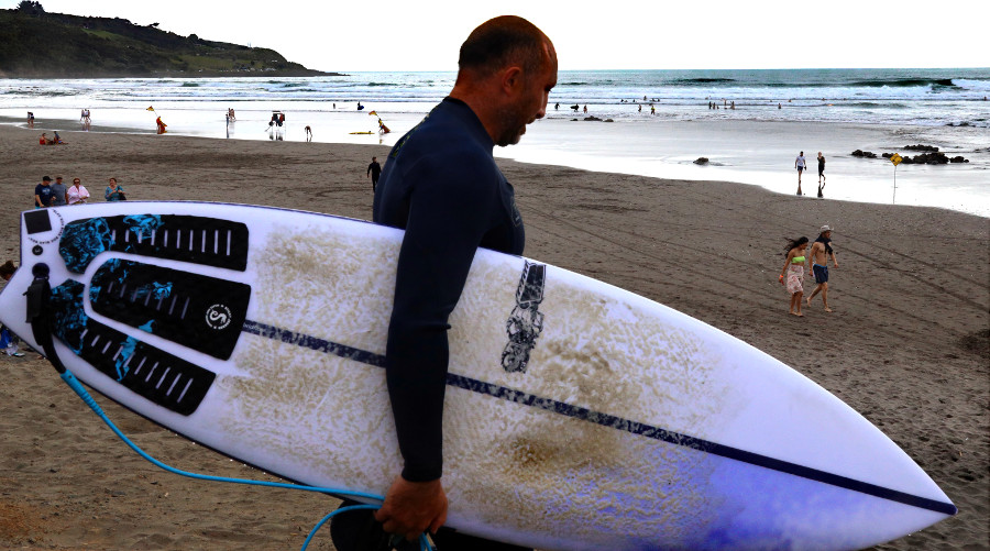 Surfer Ngarunui on the way in Raglan, New Zealand