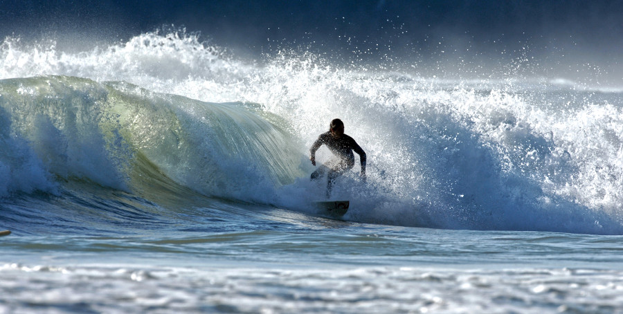 Surfing at Piha Beach, New Zealand