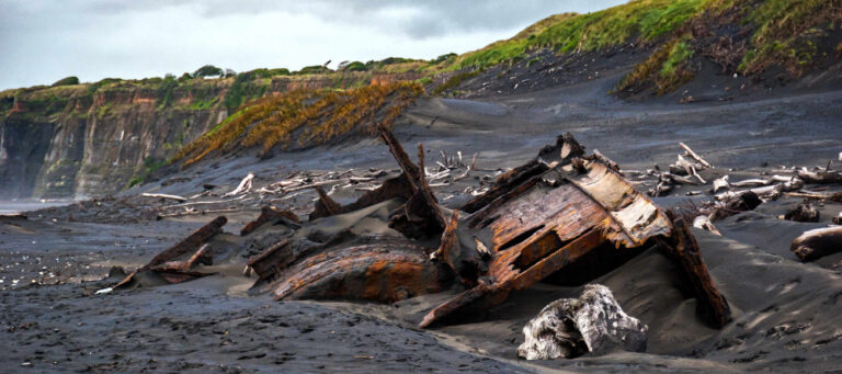 Wreck of the SS Waitangi lies half submerged on Patea breakwater beach in New Zealand