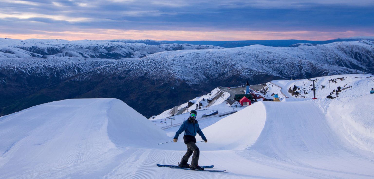 a man is ready for skiing in front of a half pipe, New Zealand