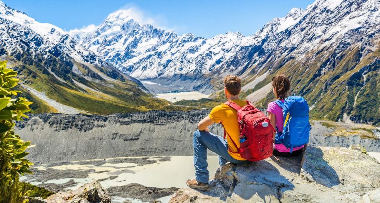 Backpackers couple hiking looking Mt Cook, New Zealand