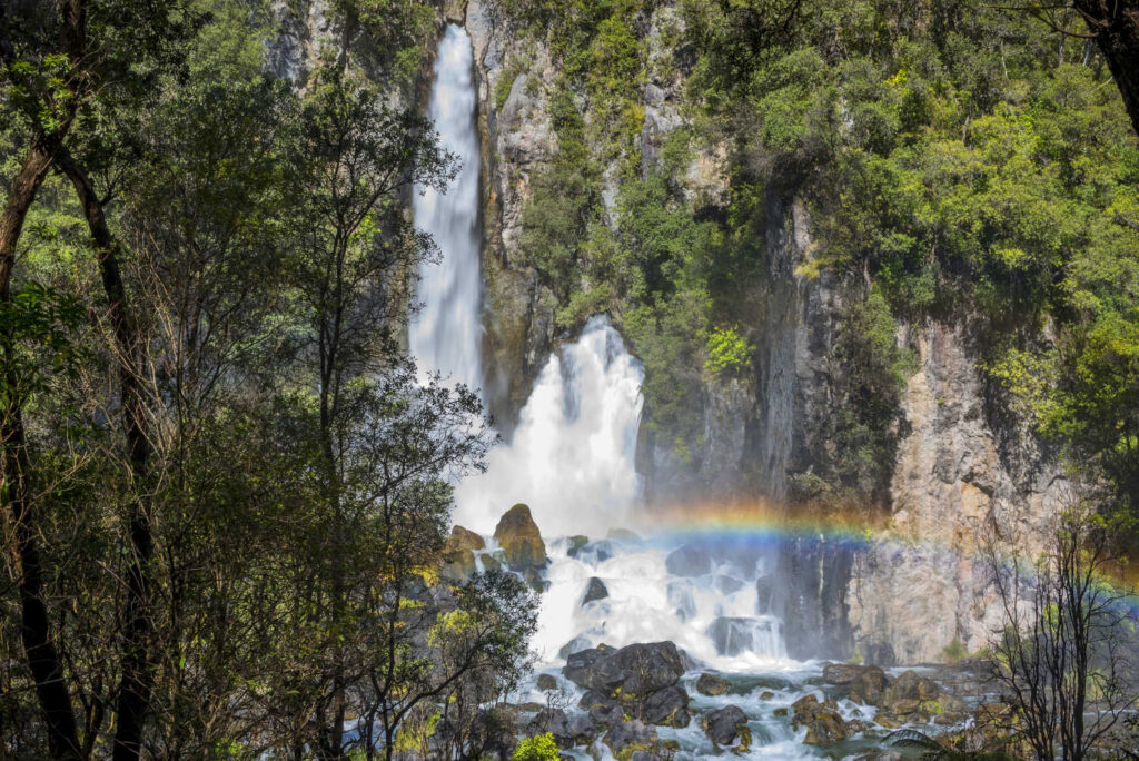 Tarawera Falls with a visible rainbow in New Zealand