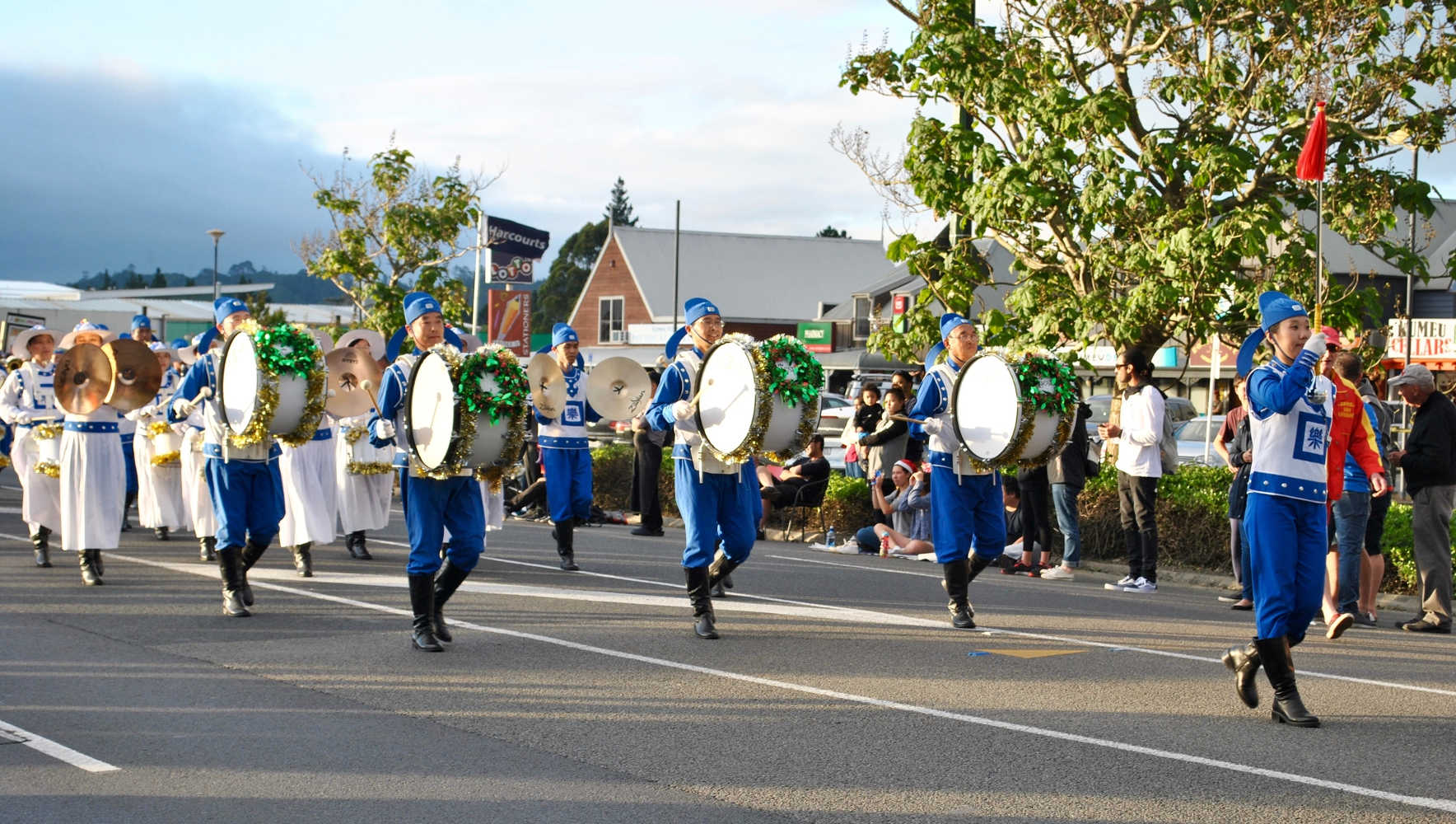 Hari Krishna band marching during a Christmas street parade in Kumeu Auckland New zealand