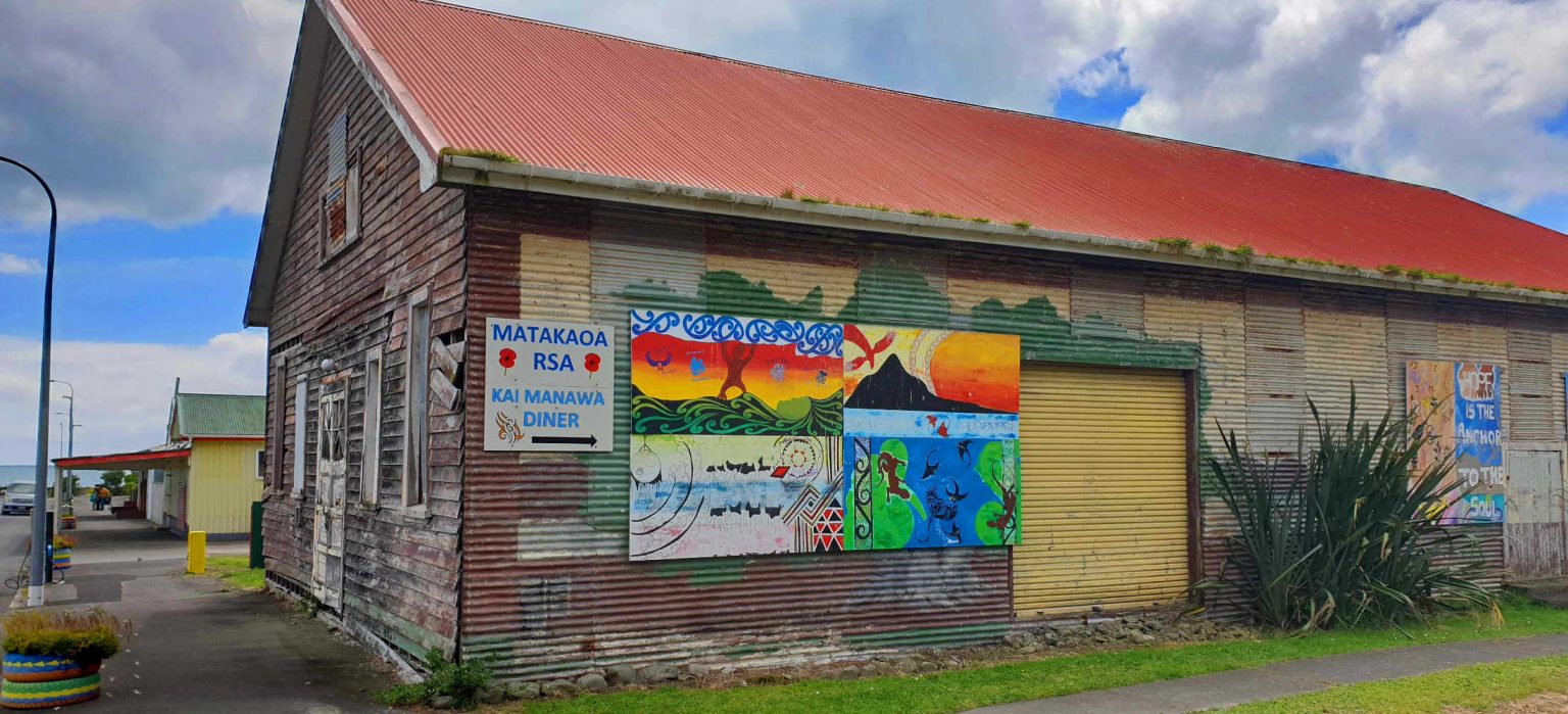Te Araroa streetscape with an abandoned building and cheerful side art, New Zealand