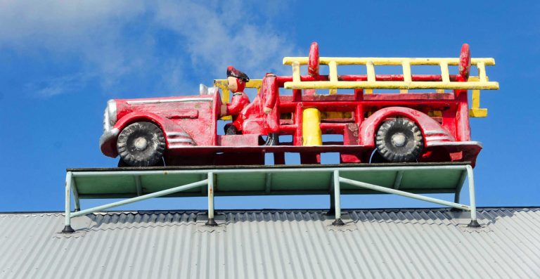 Model fire engine on roof of Fun Ho toy factory museum, Inglewood, Taranaki, North Island, New Zealand