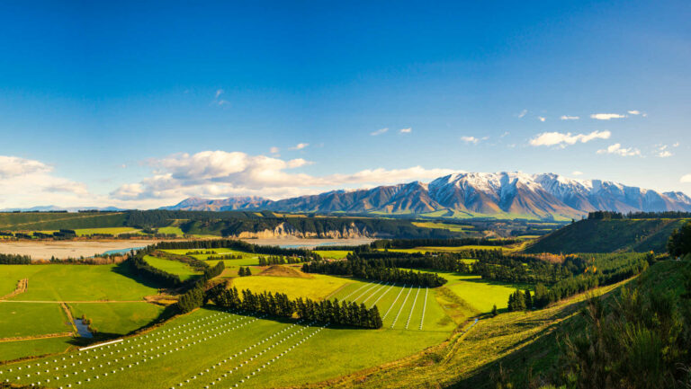 Near the village of Windwhistle looking over agricultural farming fields and the Rakaia Gorge towards Mt Hutt with a slight dusting of snow on the mountain peak, New Zealand