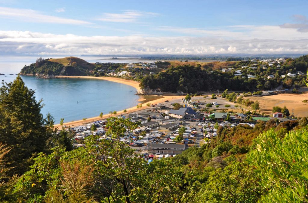 Kaiteriteri - one of the New Zealand's favourite summer holiday destinations on a beautiful morning. In the background are the towns of Mapua, Motueka and Nelson.