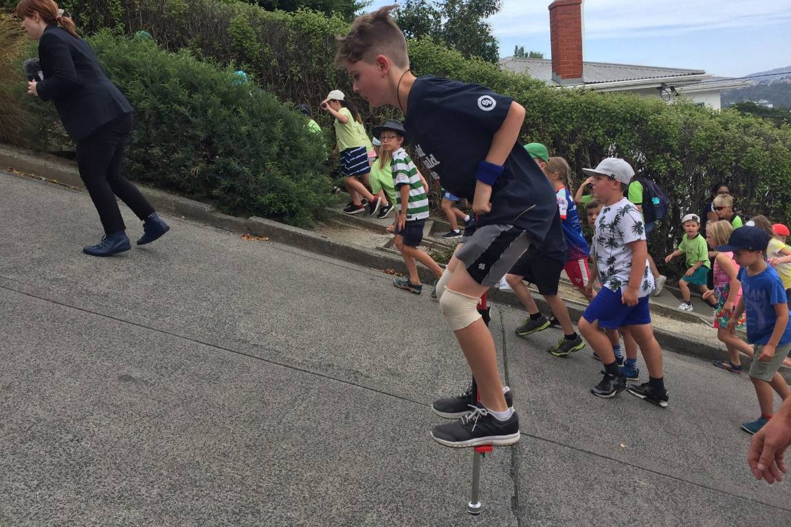 11-year-old rides pogo stick up the world's steepest street, Dunedin, Otago, New Zealand @Stuff
