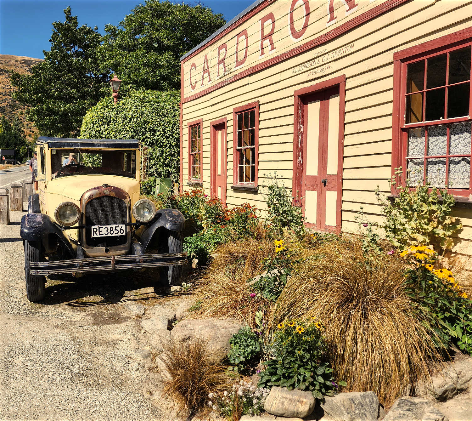 Crown Range highway selfie location, Cardrona historic hotel vintage vehicle, South Island, New Zealand