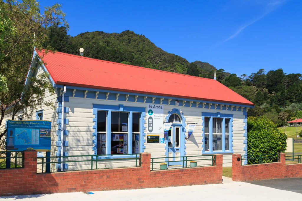 The Te Aroha i-SITE visitor information center, located in a historic 1894 building in the Te Aroha Domain park, New Zealand