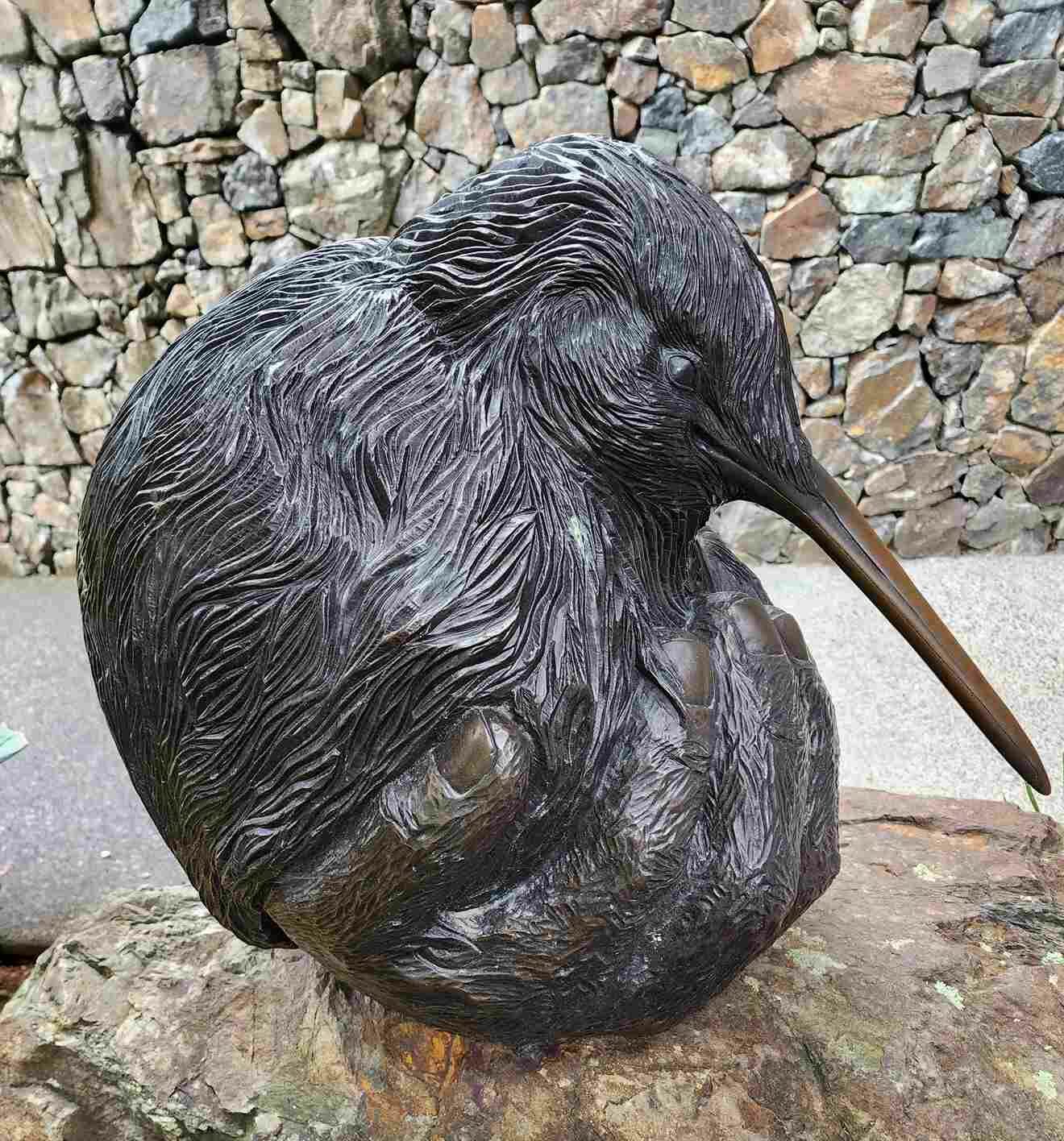 Sculpture Hand protecting baby kiwi chick by Susan Dinkelacker outside the Whangarei Quarry Gardens at the Quail Cafe entrance